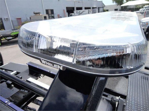 Tow truck front emergency light bar on a Ram 5500 SLT chassis showing a Whelen light bar.