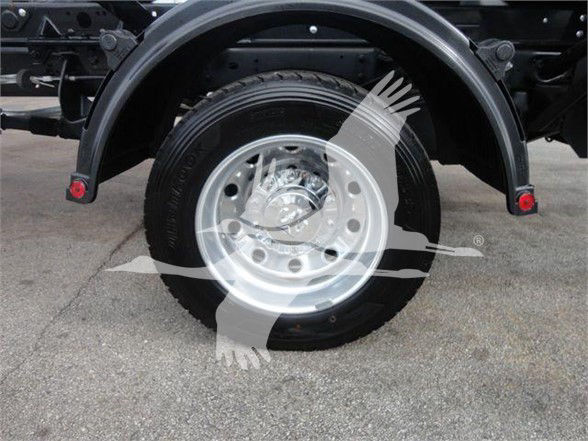 Ram 5500 hooklift truck rear wheel and fender showing wheel hub and tire with plastic ram image watermark.
