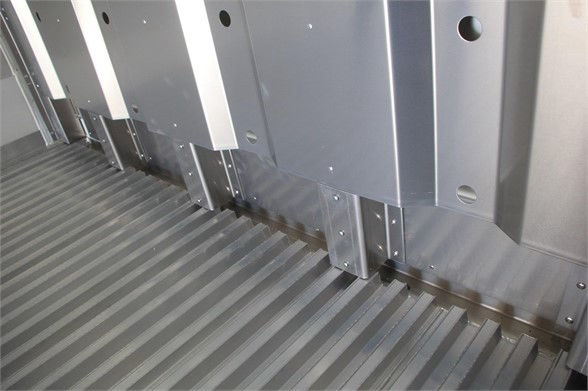 Interior of CIMC refrigerated container trailer showing ribbed metal floor and vertical metal wall panels.