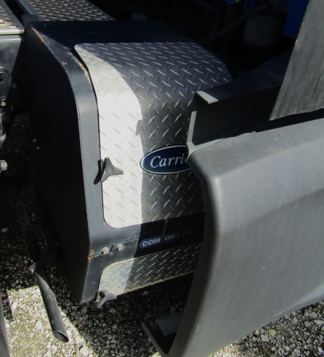 Truck fender and side step area showing diamond plate with Carrier logo and Comfort Pro label visible.