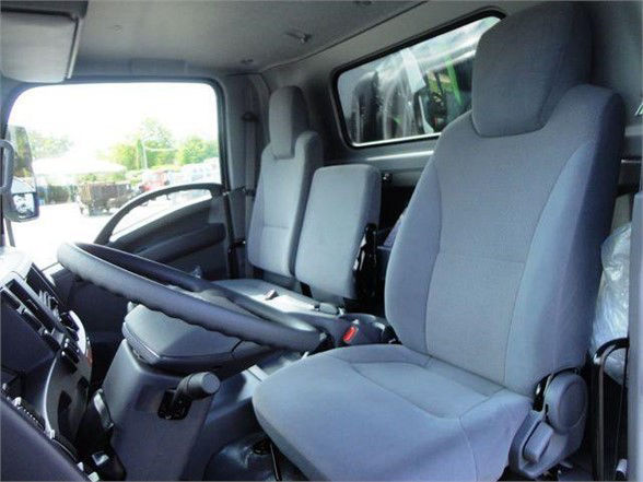 Isuzu NPR HD truck cab interior showing front seats and steering wheel, gray fabric seats and dashboard.