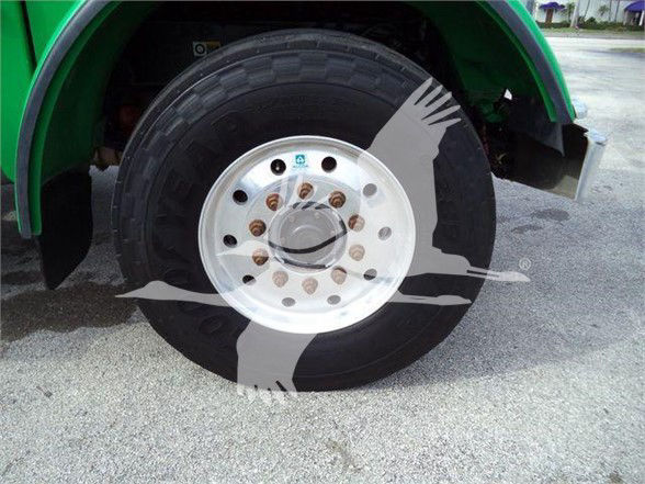 Wheel and tire assembly on a 2014 Peterbilt 367 from side view, showing front steel rim with lug nuts.