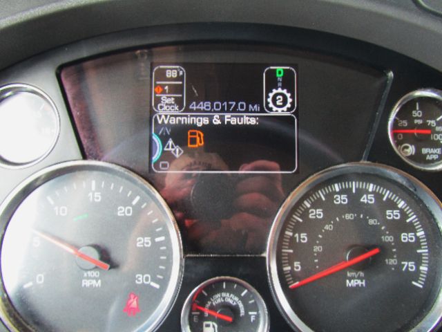 Dashboard of a 2020 Kenworth T680 showing instrument cluster with speedometer and tachometer, digital warnings display reading 'Warnings & Fauts' and odometer 446,017.0 miles.