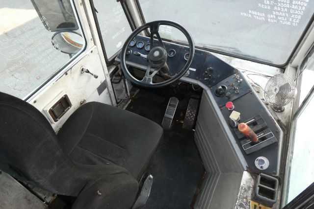 Ottawa yard truck cab interior showing steering wheel, dashboard gauges, two pedals, and control levers.
