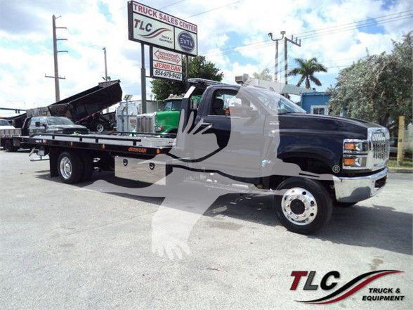 Tow truck from 2023 International CV with flatbed, VIN 1HTKTSWK6PH441635, stock J41635, showing TLC Truck & Equipment logo in corner.