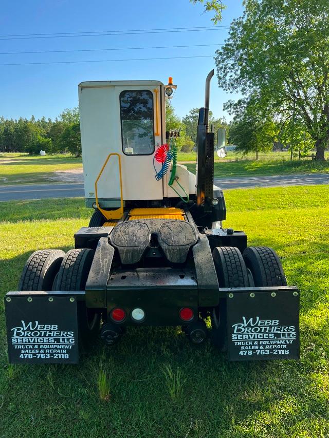 Kalmar Ottawa T2 yard truck cab rear view showing tires, rear lights, and WebB Brothers mudflaps with contact number.