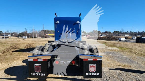 Kenworth W900L truck rear view showing fifth wheel and dual rear axles, with mud flaps marked TruckWorx.