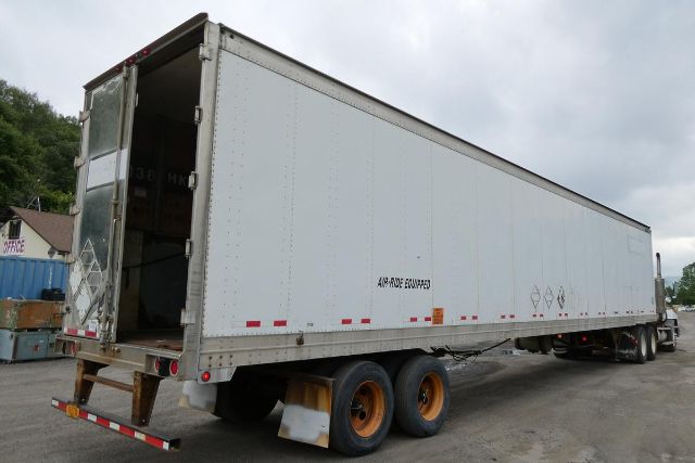 Great Dane 7311TP-SAR trailer with rear doors open, side dots, and dual rear wheels on a gravel lot.
