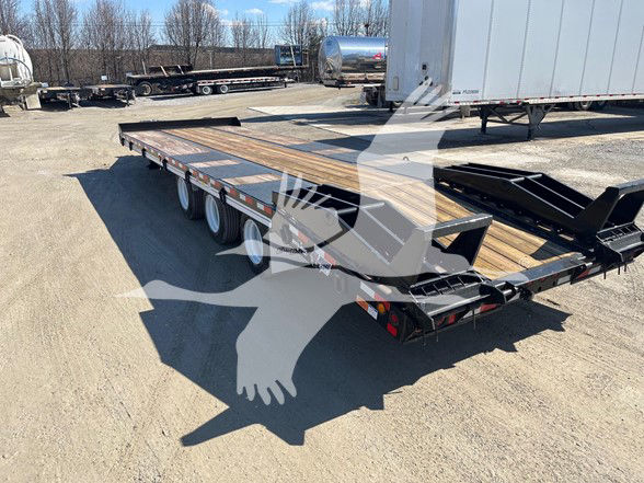 Trailer deck with wood planks and metal frame, dual-axle trailer with ramps in yard.