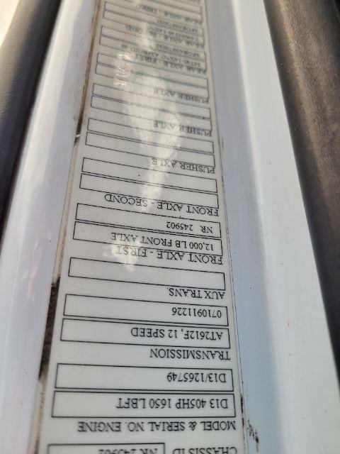 Label on Volvo VNR daycab door sill with various service and spec boxes, including PN numbers and axles. Text visible: E.R. ... PRON? Not fully legible. The vertical label shows multiple boxed entries, likely VIN/engine, axle, serials.