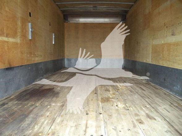 No text visible due to watermark; interior of a box truck cargo area with wooden floor and yellow walls.