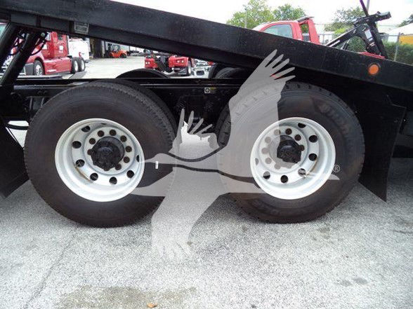 Peterbilt truck frame with dual rear axles showing wheels and tires; watermark of two hands logo across center.
