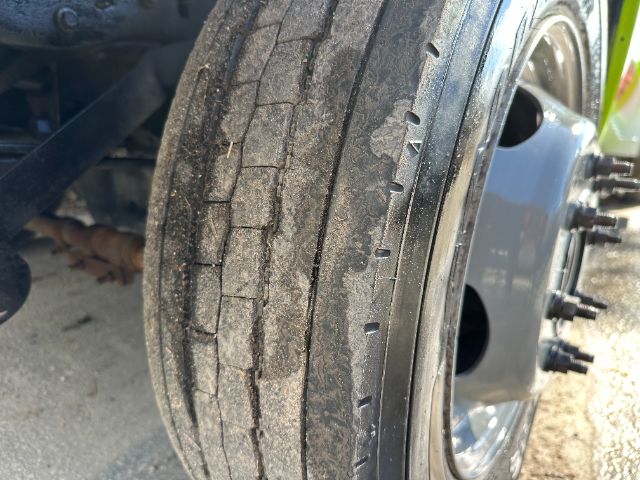 Front wheel tire with visible tread wear and rim on a Ford F550 truck.