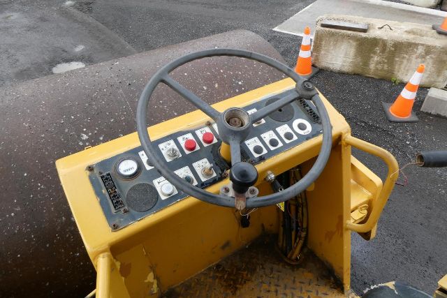 Bomag BW212D-2 compacting roller operator seat with steering wheel and control panel showing various switches and gauges.