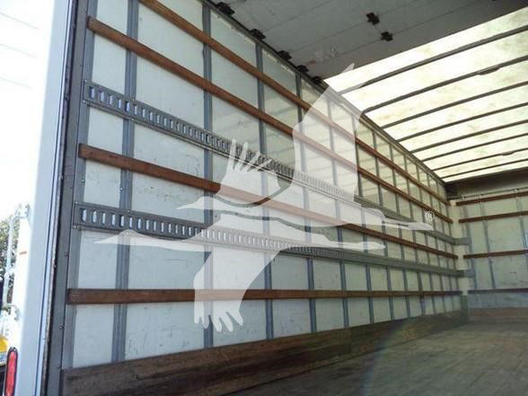 Trailer interior showing empty box truck cargo area with wooden side wall supports and metal beams.