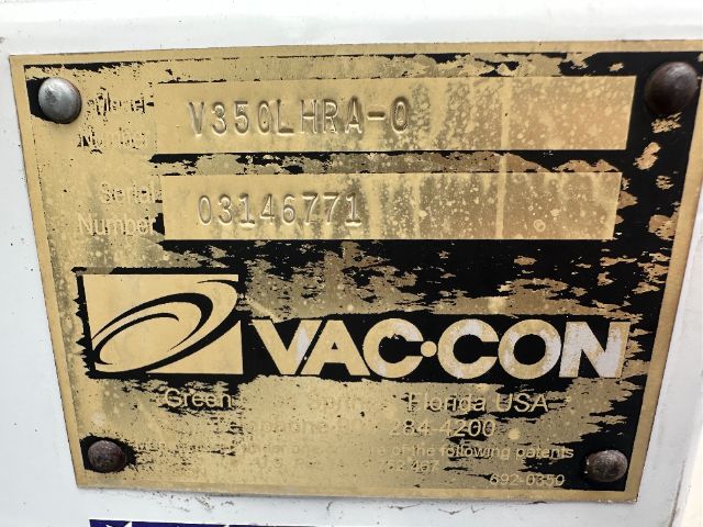 Plate showing V356L-HRA-0 and number 0314677? with VAC-CON logo and green text; dirt and screws in corners.