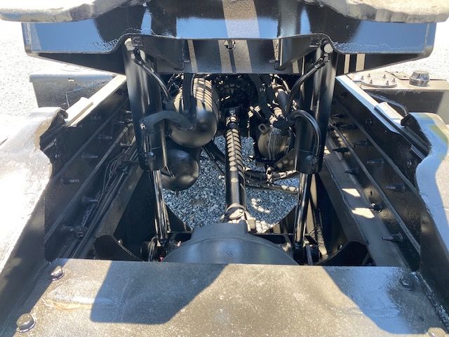 Ottawa T2 truck engine bay view with drivetrain, hoses, and hydraulic components visible.