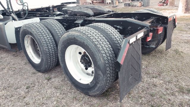 Trucks rear axle view showing dual rear wheels and mud flaps on the chassis.