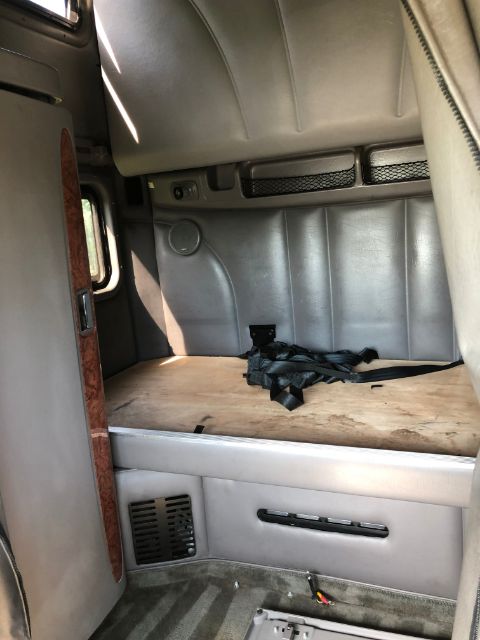 Peterbilt 387 truck interior cab area with seat belt and wood trim visible