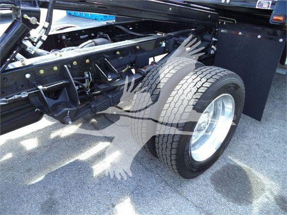 Ram 5500 chassis and dual rear wheels with exposed frame and suspension components; large treaded tire visible on the rear wheel.