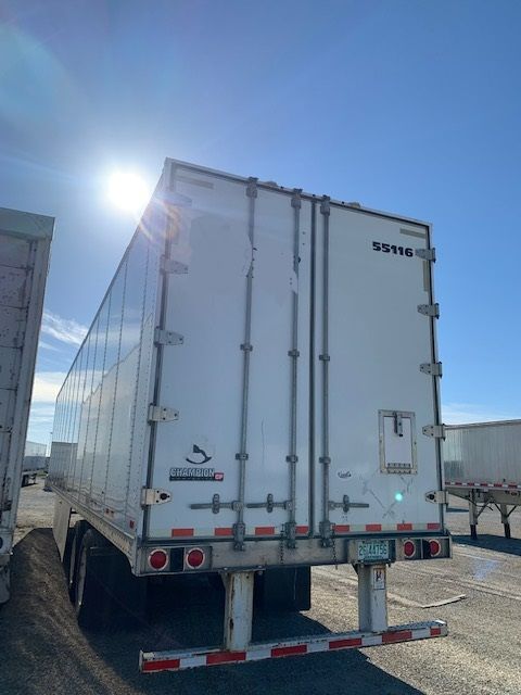 Great Dane Champion trailer rear view showing SS116 on door and Gracious brand logo with license plate visible.