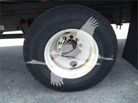 Truck rear wheel and white steel rim with tire on a reefer truck, showing wheel hub and lug nuts.