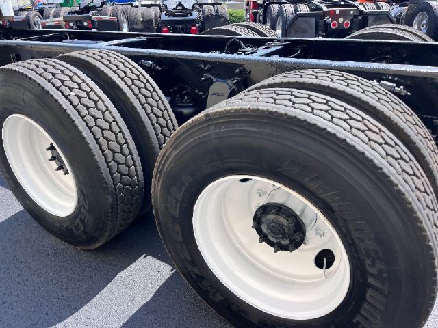 Freightliner M2 chassis showing dual rear axles with white steel wheels and Bridgestone tires.