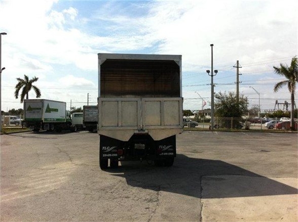 Rear view of a 16-foot dump body on a truck trailer with an open-top dump bed.
