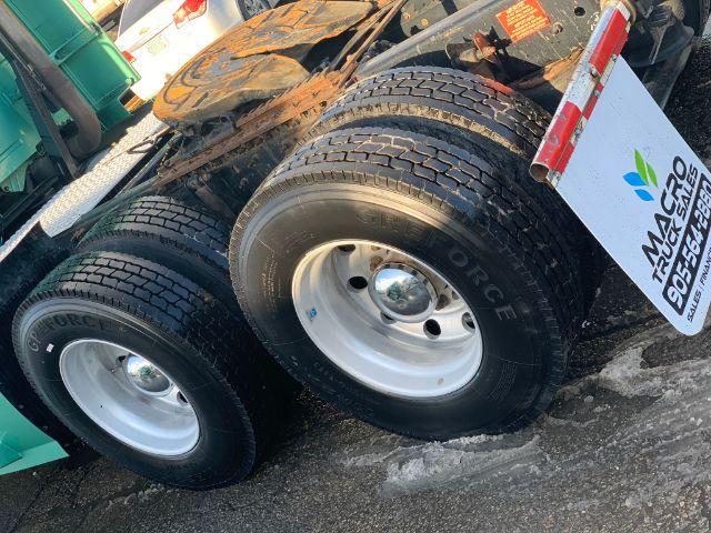 Volvo VNL 670 truck axle with dual rear wheels and mud flaps, stock number 0770, used conventional sleeper truck listing.
