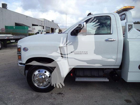 Chevrolet Silverado 6500HD tow truck side view showing cab and front wheel, with 'CHEVROLET