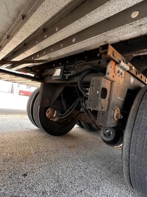 Trailer undercarriage showing suspension components, air lines, and wheel assemblies on a CIMC Cool Globe trailer.