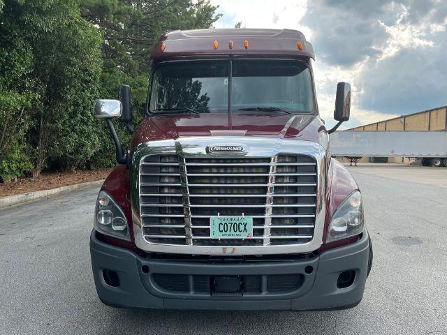 Front view of a maroon Freightliner Cascadia 2015 with large chrome grille, Georgia license plate C070CX, hood and cab mirrors visible.