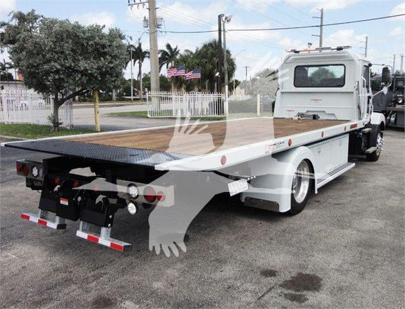 Truck bed with flatbed of a 2025 Mack MD6 tow truck showing rear view and flat deck.