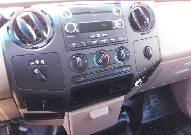 Dashboard area of a 2009 Ford F-250 interior showing center console with radio, climate controls, and cup holders.