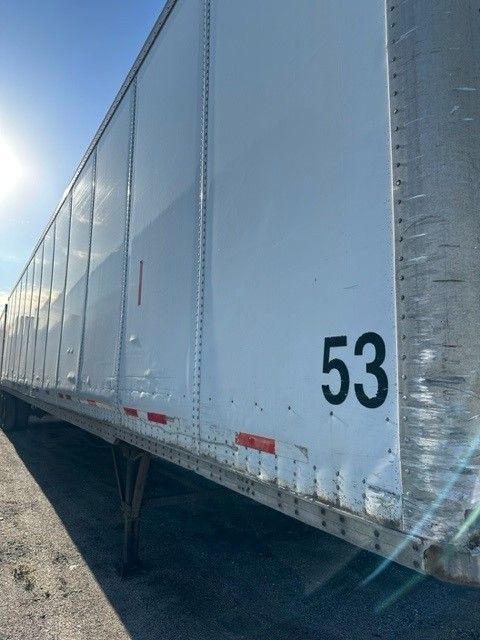 Truck trailer side with number 53 and Duraplate marking along edge.