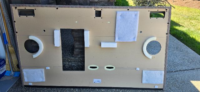 Door panel from Volvo 760 sleeper truck showing circular speaker housings and various white foam padding blocks.