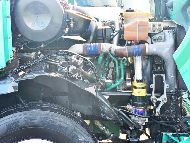 Volvo VNL 670 engine bay showing air intake, hoses, radiator, hydraulic lines, and front suspension components.