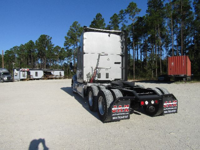 Kenworth T680 cab chassis rear view showing dual rear axles ands bare frame
