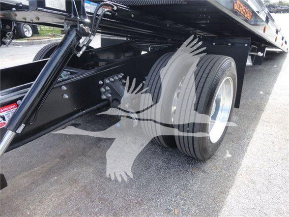 Rear section of a Mack MD6 truck showing dual rear tires and undercarriage hardware.