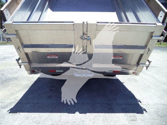 Isuzu NQR dump truck bed rear view showing tailgate and hydraulic hinges.
