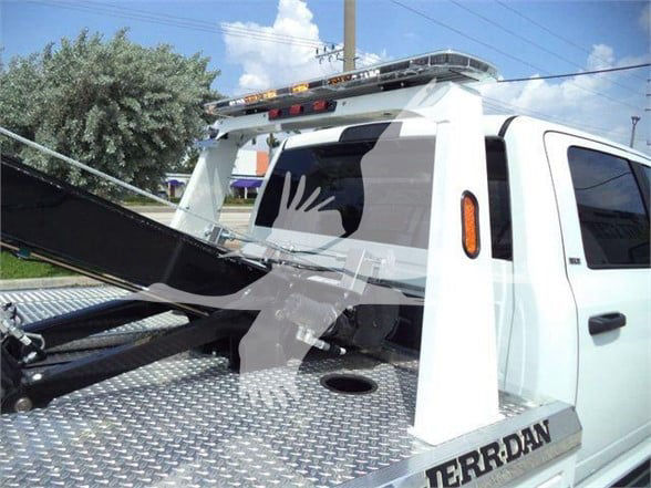 Ram 5500 tow truck bed with tilt-bed hoist and graphic ‘TERRAN’ visible on side, rear view.