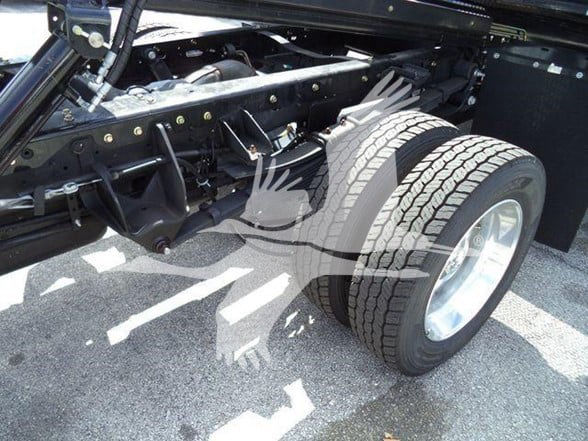 Ram 5500 chassis with dual rear wheels, frame rails, and suspension components visible; rubber tires mounted on alloy wheels.
