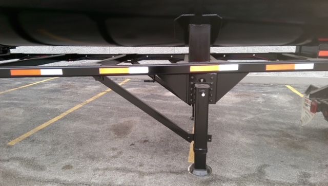 Trailer undercarriage showing support legs and frame for a 40 ft round bottom dump trailer.