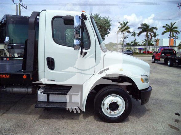 Front side view of a white 2012 Freightliner Business Class M2 106 cab shown in a flatbed setup.