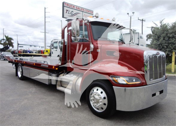Peterbilt 337 tow truck in red with chrome grille and flatbed, stock number J06173 FM, category Tow, new truck.