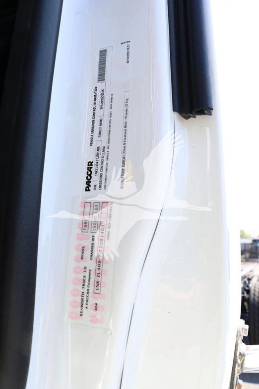 Vehicle door jamb showing Pacar label with barcodes and truck specifications for a Kenworth T880 cab and chassis.
