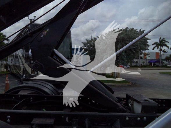Truck undercarriage with hydraulic components; no legible labels clearly visible.