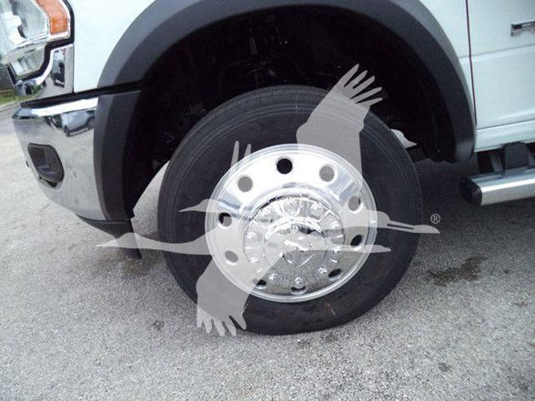 Truck front wheel and fender with chrome hubcap and tire, Ram 4500 SLT; visible wheel well and side step.