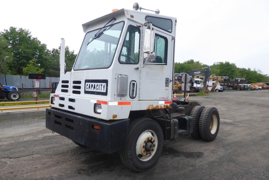 Capacity TJ5000 yard truck cab and chassis showing front view with white body, black bumper, and rust on lower panels.