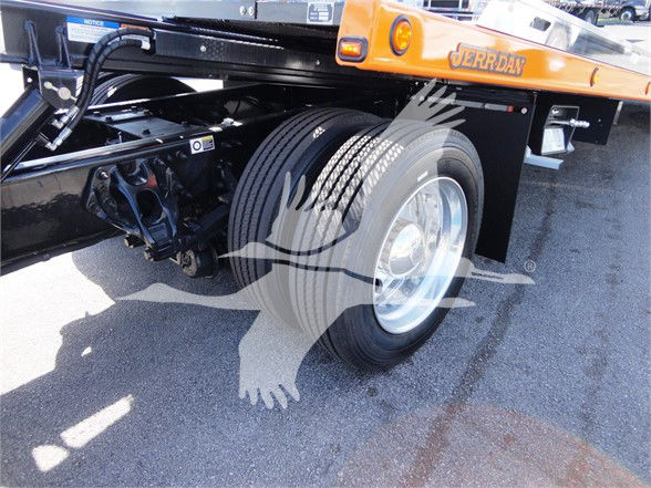 Peterbilt 337 tow truck chassis showing dual rear wheels and suspension undercarriage.